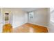Bedroom featuring hardwood floors and a glimpse into an adjacent bathroom at 415 S Parfet St, Lakewood, CO 80226