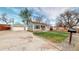 Charming single-story home with a well-maintained lawn, detached garage, and a welcoming front porch at 415 S Parfet St, Lakewood, CO 80226