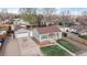 Charming single-Gathering home with a detached garage and green lawn at 415 S Parfet St, Lakewood, CO 80226