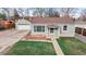 Charming single-Gathering home with a detached garage and green lawn at 415 S Parfet St, Lakewood, CO 80226
