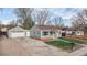 Charming single-story home with a detached garage and well-maintained lawn at 415 S Parfet St, Lakewood, CO 80226