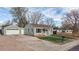 Charming single-story home featuring a detached garage, well-kept lawn, and inviting curb appeal at 415 S Parfet St, Lakewood, CO 80226