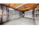 Spacious garage with concrete floor, window, wood framing and metal clad walls offers a practical space at 415 S Parfet St, Lakewood, CO 80226