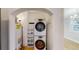 Convenient laundry room featuring a stacked washer and dryer at 415 S Parfet St, Lakewood, CO 80226