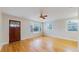 Cozy living room with hardwood floors, large windows for natural light, and a front door at 415 S Parfet St, Lakewood, CO 80226
