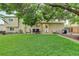 Backyard features lush green lawn, patio seating, grill, and mature tree, creating a relaxing outdoor space at 10527 Pierson Cir, Westminster, CO 80021