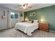 Cozy bedroom featuring a ceiling fan, neutral carpet, and an olive green accent wall at 10527 Pierson Cir, Westminster, CO 80021