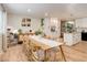 Dining room featuring a long wood table set for six with a view into the kitchen at 10527 Pierson Cir, Westminster, CO 80021
