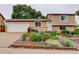 Charming home with a well-maintained front yard featuring colorful flowers and lush greenery at 10527 Pierson Cir, Westminster, CO 80021