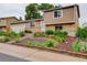 Charming home with a well-maintained front yard featuring colorful flowers and lush greenery at 10527 Pierson Cir, Westminster, CO 80021