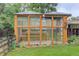 This backyard greenhouse with wood frame and glass panels is ready for gardening year-round at 10527 Pierson Cir, Westminster, CO 80021