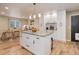 Open kitchen and dining area featuring white cabinets, an island with seating, and stainless steel appliances at 10527 Pierson Cir, Westminster, CO 80021