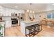 Bright, open kitchen with island, stainless appliances, white cabinetry, and adjoining dining area at 10527 Pierson Cir, Westminster, CO 80021