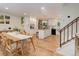Bright, open kitchen with island, stainless appliances, white cabinetry, and adjoining dining area at 10527 Pierson Cir, Westminster, CO 80021