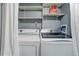 Efficient laundry room featuring modern washer and dryer units, shelving, and ample storage space at 10527 Pierson Cir, Westminster, CO 80021