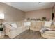 Cozy living room with a large sectional sofa, plush carpet, and neutral-toned walls at 10527 Pierson Cir, Westminster, CO 80021