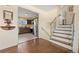 Open entryway view of kitchen with stainless appliances, staircase and wood flooring at 2567 S Vrain St, Denver, CO 80219