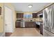 Modern kitchen with stainless steel appliances, granite countertops, and ample cabinet space at 2567 S Vrain St, Denver, CO 80219