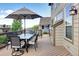 Back deck features a large patio umbrella, outdoor dining set, and relaxing backyard views at 11951 Singing Winds St, Parker, CO 80138
