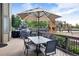 Back deck features a patio umbrella, grill, and playground at 11951 Singing Winds St, Parker, CO 80138