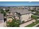 Aerial view of the home's backyard featuring a deck with furniture, playground, and landscaped yard at 11951 Singing Winds St, Parker, CO 80138