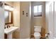 Bathroom featuring pedestal sink, toilet and window at 11951 Singing Winds St, Parker, CO 80138