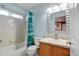 Bathroom featuring shower-tub combo with patterned curtain, mirror over sink, and tile flooring at 11951 Singing Winds St, Parker, CO 80138