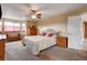 Spacious bedroom features a ceiling fan, soft carpet, and a comfortable bed with decorative pillows at 11951 Singing Winds St, Parker, CO 80138