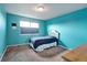 Bedroom featuring aqua walls, carpet flooring, window with shade and double bed at 11951 Singing Winds St, Parker, CO 80138