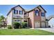 Beautiful two-story home featuring a brick facade and well-manicured lawn at 11951 Singing Winds St, Parker, CO 80138