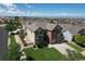 Attractive two-story home featuring a brick facade, attached two car garage, and well-maintained landscaping at 11951 Singing Winds St, Parker, CO 80138
