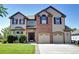 Charming two-story home featuring a brick facade and an attached two-car garage at 11951 Singing Winds St, Parker, CO 80138
