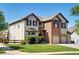 Attractive two-story home featuring a brick facade, attached two car garage, and well-maintained landscaping at 11951 Singing Winds St, Parker, CO 80138