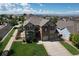 Attractive two-story home featuring a brick facade, attached two car garage, and well-maintained landscaping at 11951 Singing Winds St, Parker, CO 80138