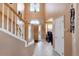 Grand foyer with soaring ceilings, tile floors, and a staircase leading to the upper level at 11951 Singing Winds St, Parker, CO 80138