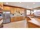 Charming kitchen featuring wood cabinetry, stainless steel refrigerator, and granite countertops at 11951 Singing Winds St, Parker, CO 80138