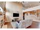 Open living area featuring a fireplace, hardwood floors, and a staircase leading to the second floor at 11951 Singing Winds St, Parker, CO 80138