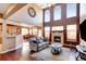 Open concept living room with a fireplace, hardwood floors, and a breakfast bar at 11951 Singing Winds St, Parker, CO 80138