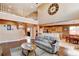 Spacious living room with a high ceiling, a large clock, and an open floor plan at 11951 Singing Winds St, Parker, CO 80138
