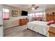 Well-lit main bedroom featuring carpet flooring, dresser, tv and windows with shades at 11951 Singing Winds St, Parker, CO 80138