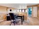 Office area featuring desk, carpet flooring, and neutral walls with access to other rooms at 11951 Singing Winds St, Parker, CO 80138