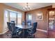 Elegant office space with a large bay window, dark wood floors, and a modern chandelier at 11951 Singing Winds St, Parker, CO 80138