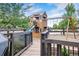 Beautiful backyard playground features a multi-level playhouse with a slide and swing set at 11951 Singing Winds St, Parker, CO 80138