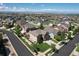 Aerial view of a neighborhood with homes and streets, showing the property's location within the community at 11951 Singing Winds St, Parker, CO 80138