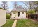 Backyard with a wood patio and outdoor dining set, green lawn, and a white detached garage at 250 S Ogden St, Denver, CO 80209