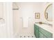 Classic bathroom featuring an updated vanity, a tub and shower, and a round mirror at 250 S Ogden St, Denver, CO 80209