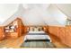 A cozy bedroom with wood paneled walls, built-in shelving, and pitched ceilings for a rustic, comfortable feel at 250 S Ogden St, Denver, CO 80209