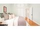 Well-lit bedroom with hardwood floors, a full-sized bed, and closet with white bi-fold doors at 250 S Ogden St, Denver, CO 80209