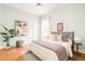 Relaxing bedroom features a full-sized bed, hardwood floors, and large window for natural light at 250 S Ogden St, Denver, CO 80209