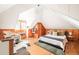 Bedroom featuring wood paneled walls, vaulted ceiling, seating area, and a cozy bed at 250 S Ogden St, Denver, CO 80209